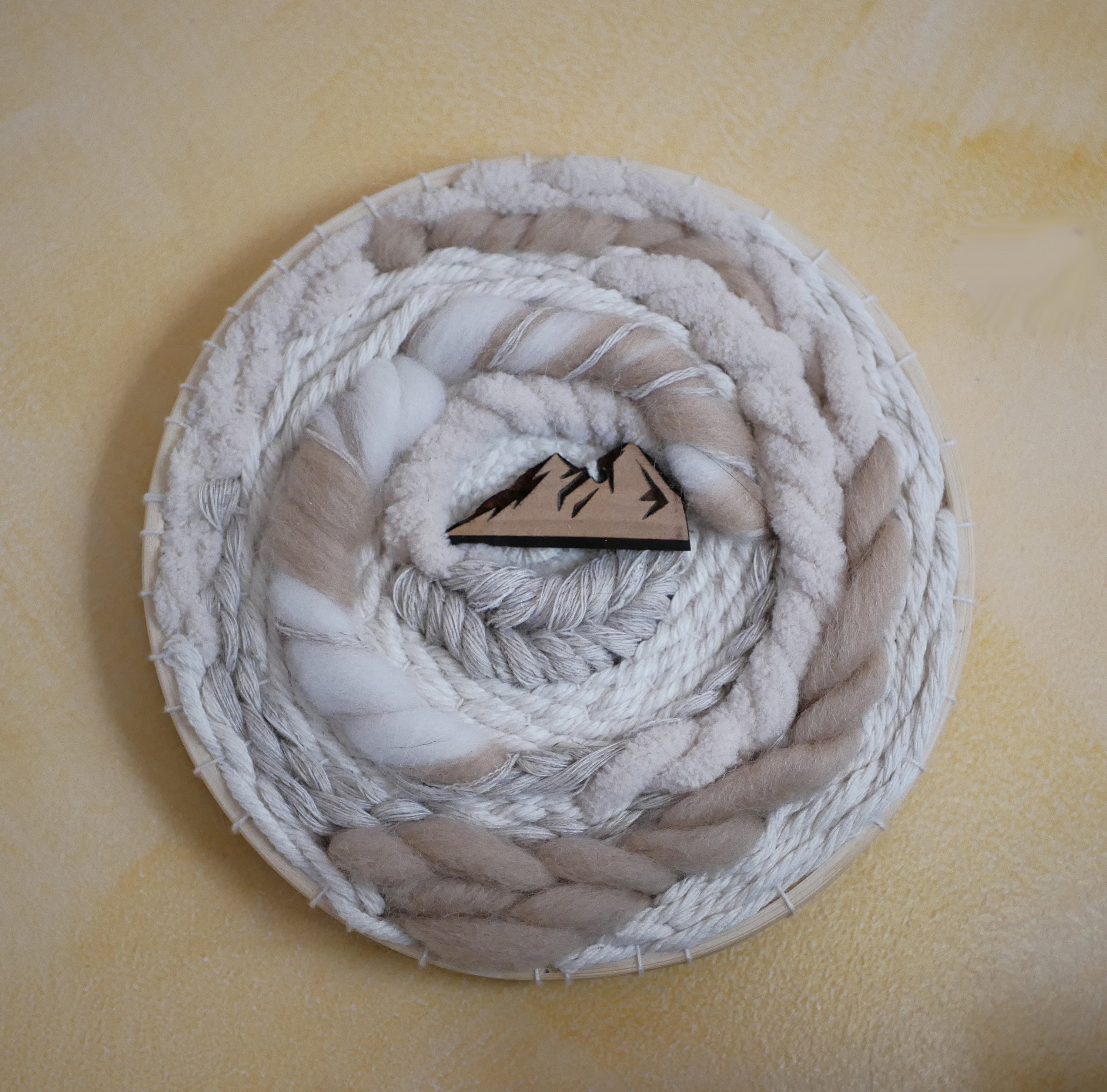 Tissage mural cadre rond en macram&eacute; et d&eacute;cor montagne en laines blanches et beiges