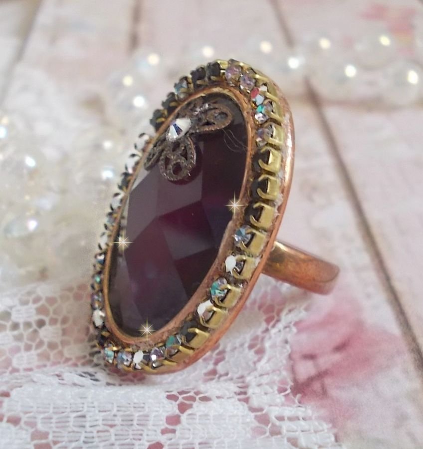 Anel Chic Burgundy criado com cristais PureCrystal, um selo em forma de flor e um cabochon de vidro.