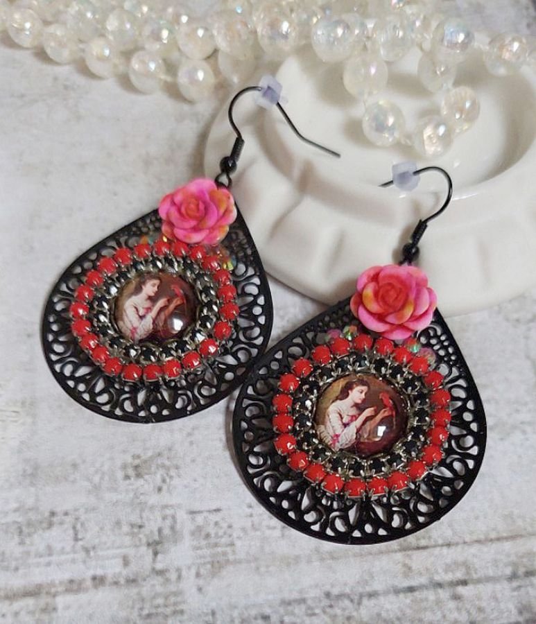 BO Look Coco criado com cabochons de lupa representando uma mulher com o seu papagaio, pingentes pretos de filigrana, contas de vidro e resina