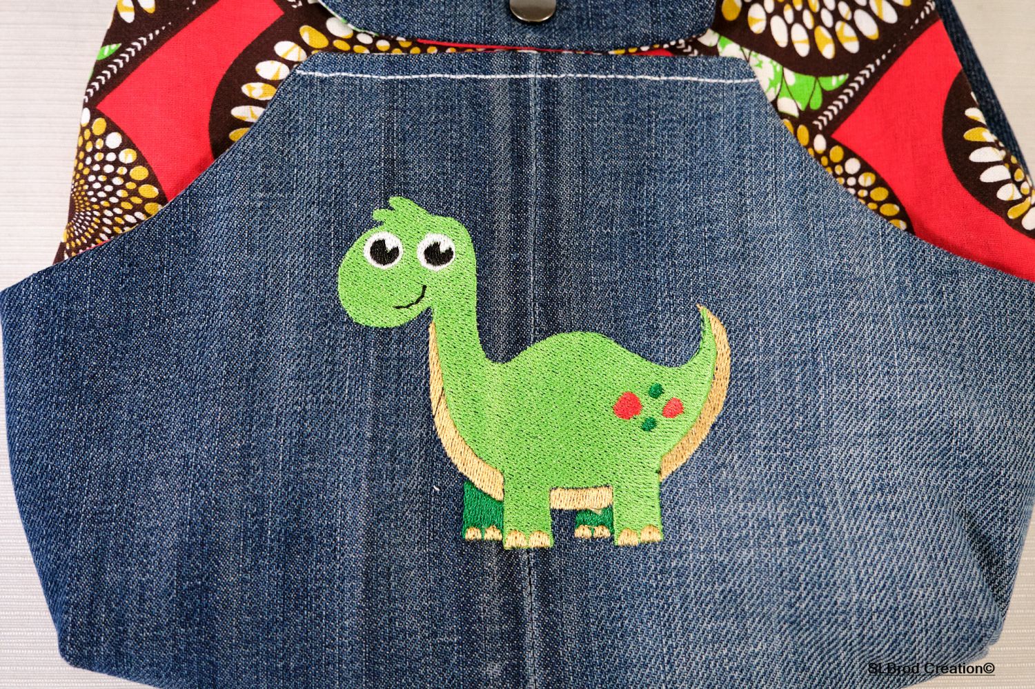 Mochila de criança bordada com dinossauro e cera para ser personalizada com o seu nome